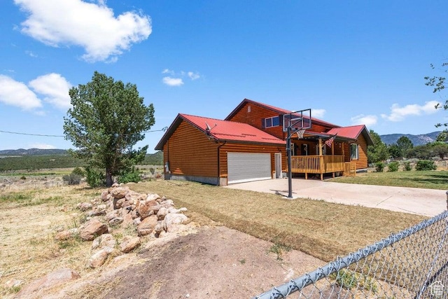 770 W Carter Dr, Pine Valley, UT 84781 - view of front of home featuring an attached garage, driveway, a mountain view, and metal roof