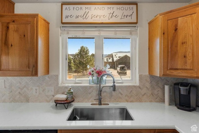 770 W Carter Dr, Pine Valley, UT 84781 - kitchen featuring light countertops, tasteful backsplash, brown cabinetry, and a sink