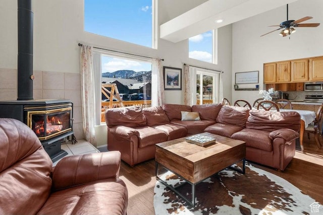 770 W Carter Dr, Pine Valley, UT 84781 - living room with wood finished floors, a wood stove, a towering ceiling, and a ceiling fan