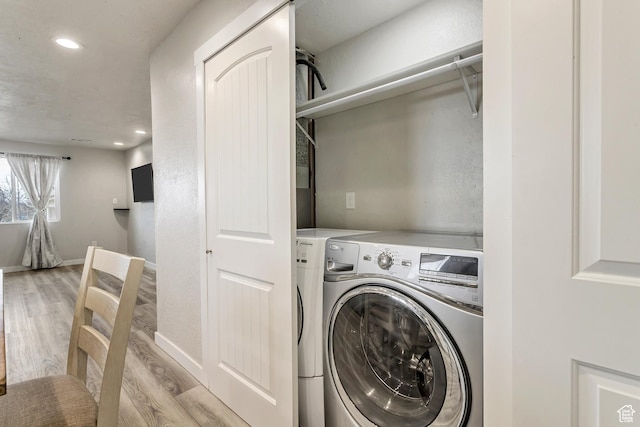 3306 N Fairfield Rd, Layton, UT 84041 - washroom with separate washer and dryer, baseboards, laundry area, and light wood finished floors