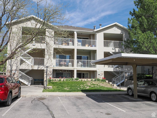 3832 S Big River Way W Unit 1, Salt Lake City, UT 84119 - view of building exterior featuring stairway and covered and uncovered parking