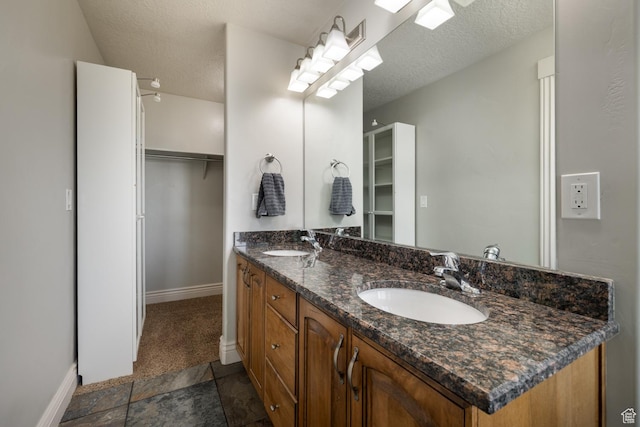 1808 E 2000 S, Naples, UT 84078 - bathroom featuring a spacious closet, baseboards, a sink, and double vanity