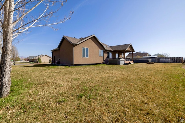 1808 E 2000 S, Naples, UT 84078 - back of house with fence, a lawn, and stucco siding