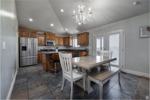 1808 E 2000 S, Naples, UT 84078 - dining room featuring baseboards, stone tile floors, a chandelier, and vaulted ceiling