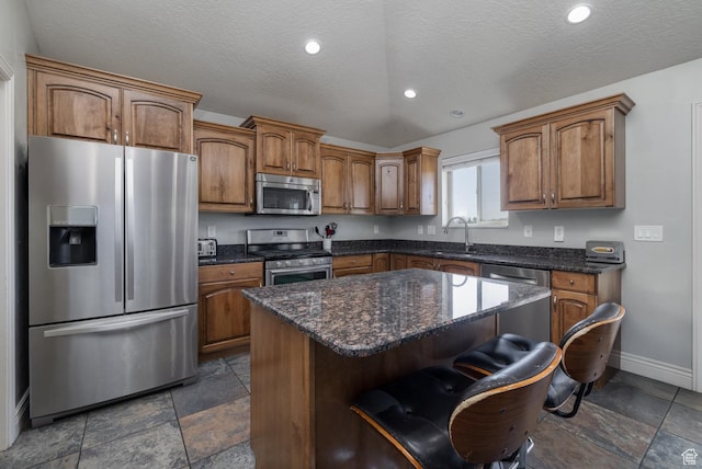 1808 E 2000 S, Naples, UT 84078 - kitchen with stone tile floors, baseboards, a sink, and appliances with stainless steel finishes