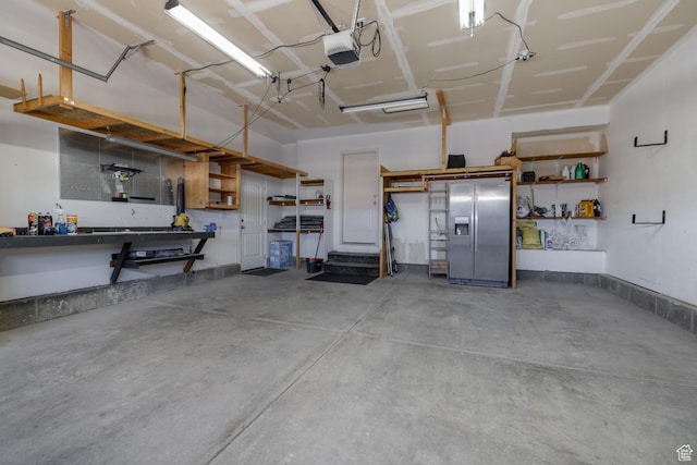 1808 E 2000 S, Naples, UT 84078 - garage with a workshop area, a garage door opener, and stainless steel fridge