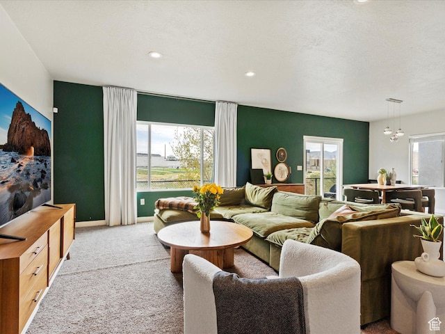 carpeted living area featuring recessed lighting and baseboards