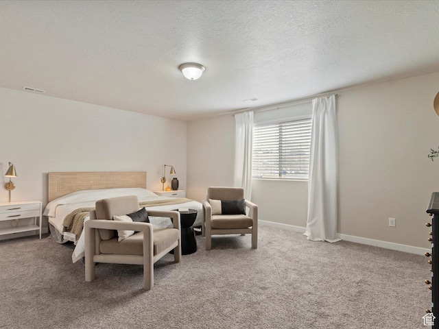 carpeted bedroom featuring a textured ceiling, visible vents, and baseboards