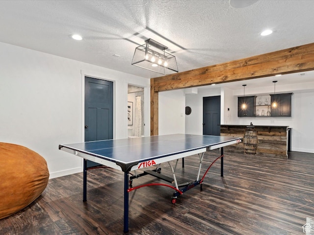 rec room with recessed lighting, a textured ceiling, baseboards, and dark wood-style flooring