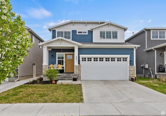 craftsman inspired home featuring driveway, stone siding, board and batten siding, an attached garage, and a front yard