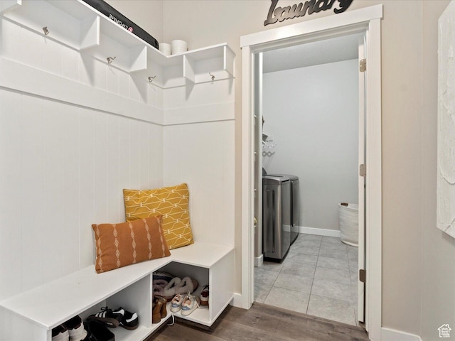 mudroom with wood finished floors and washer and dryer