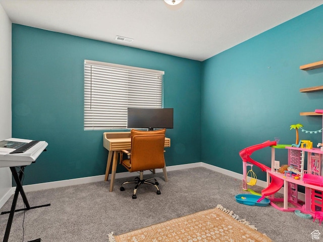 carpeted office with baseboards and visible vents