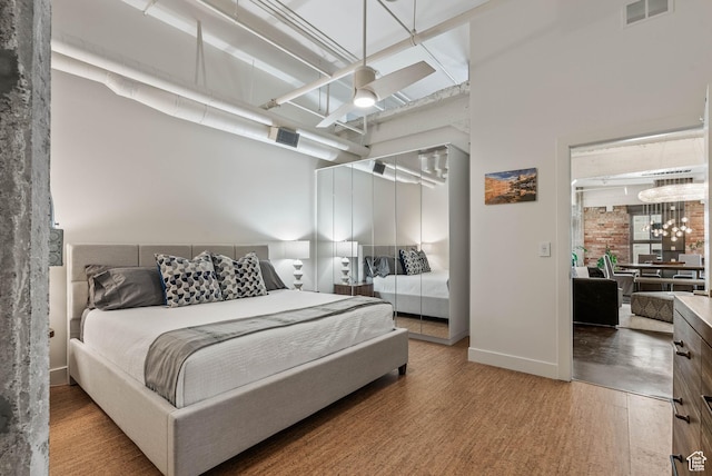 328 W 200 S Unit 505, Salt Lake City, UT 84101 - bedroom with wood finished floors, baseboards, a ceiling fan, and visible vents