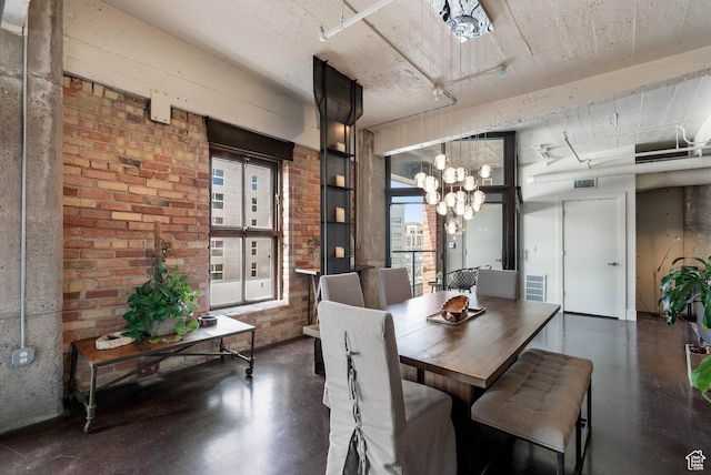 328 W 200 S Unit 505, Salt Lake City, UT 84101 - dining room with brick wall, visible vents, finished concrete floors, and an inviting chandelier