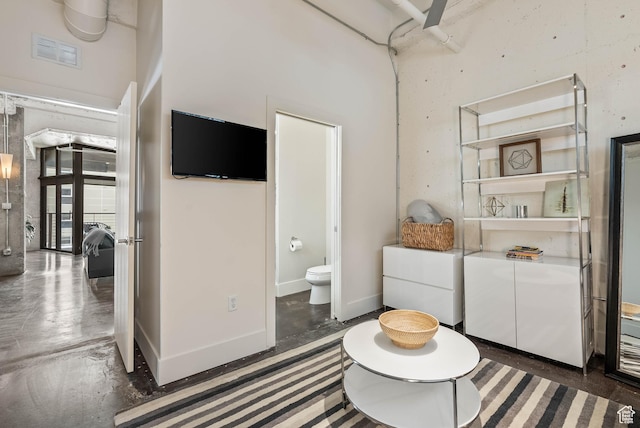 328 W 200 S Unit 505, Salt Lake City, UT 84101 - sitting room with concrete flooring, a towering ceiling, visible vents, and baseboards