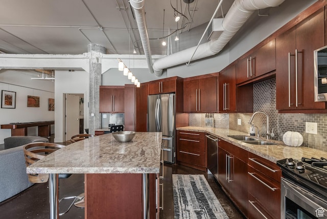 328 W 200 S Unit 505, Salt Lake City, UT 84101 - kitchen featuring a high ceiling, stainless steel appliances, a sink, light stone countertops, and a center island
