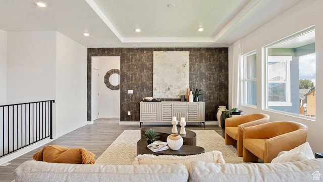 living room featuring baseboards, wood finished floors, and recessed lighting