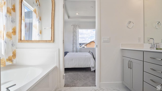 ensuite bathroom featuring ensuite bathroom, baseboards, marble finish floor, a garden tub, and vanity