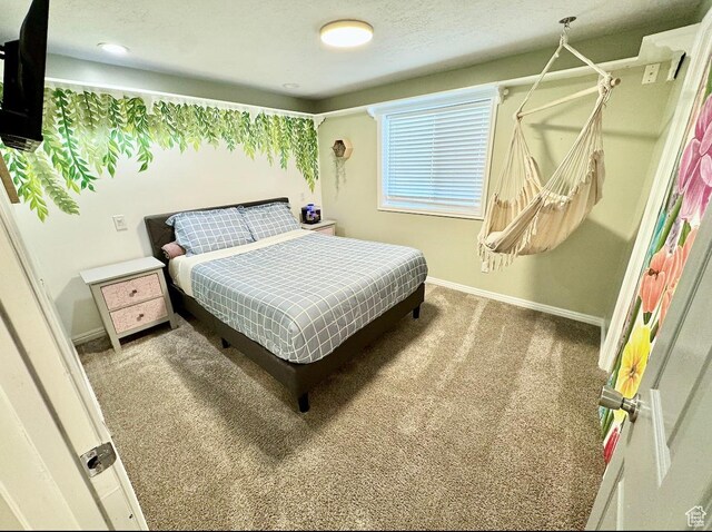 carpeted bedroom featuring baseboards