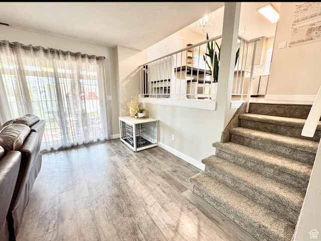 stairway featuring baseboards and wood finished floors