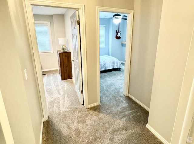 hall with carpet floors and baseboards