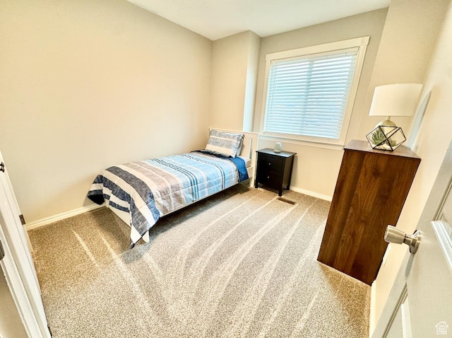 carpeted bedroom featuring baseboards