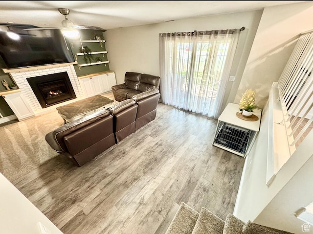 living room with ceiling fan, wood finished floors, and a fireplace