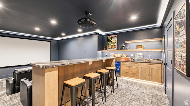 home theater with light carpet, indoor wet bar, recessed lighting, and wine cooler