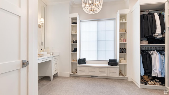 walk in closet with a notable chandelier, light carpet, and visible vents