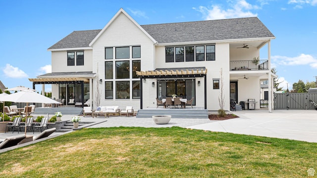 rear view of house featuring a yard, a gate, a pergola, ceiling fan, and an outdoor hangout area