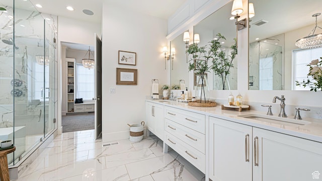 full bath featuring visible vents, a sink, and a marble finish shower