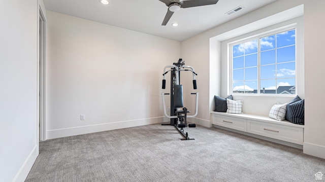 exercise room featuring light colored carpet, baseboards, a ceiling fan, and visible vents