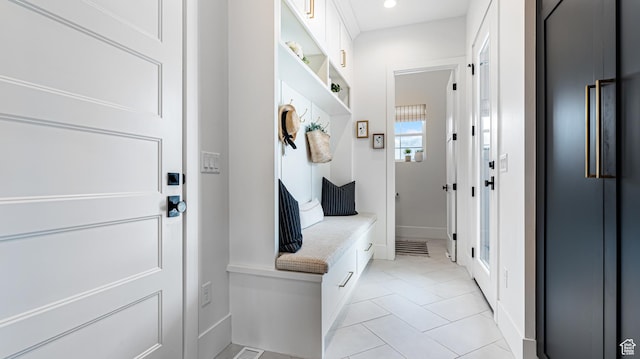 mudroom with light tile patterned flooring, baseboards, and recessed lighting