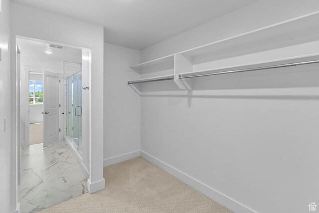 spacious closet featuring marble finish floor and visible vents