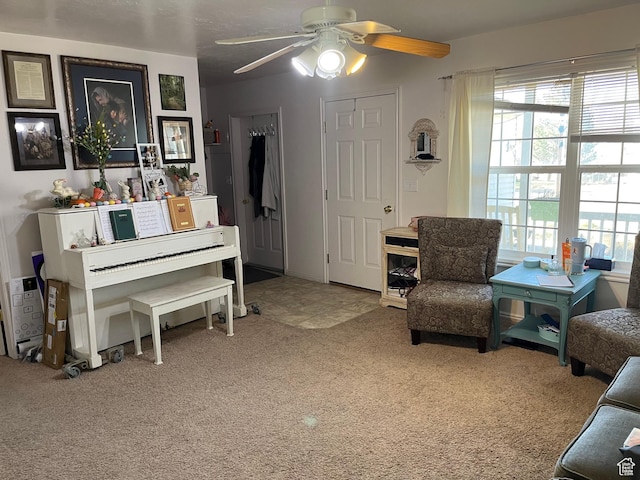 living area featuring ceiling fan and light colored carpet