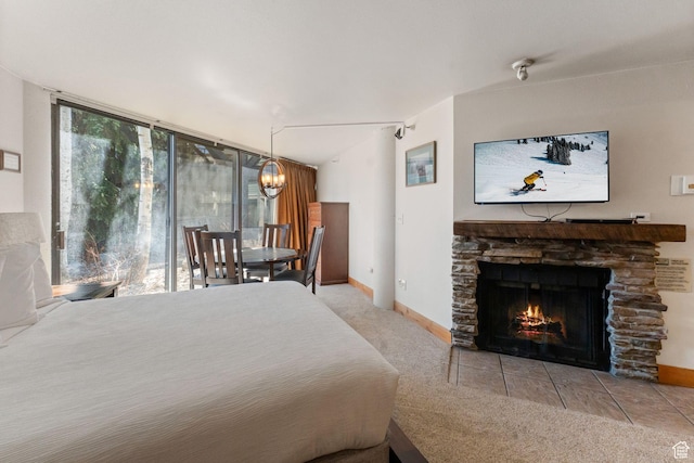 1485 S Empire Ave Unit 216, Park City, UT 84060 - carpeted bedroom featuring baseboards, a fireplace, and a notable chandelier