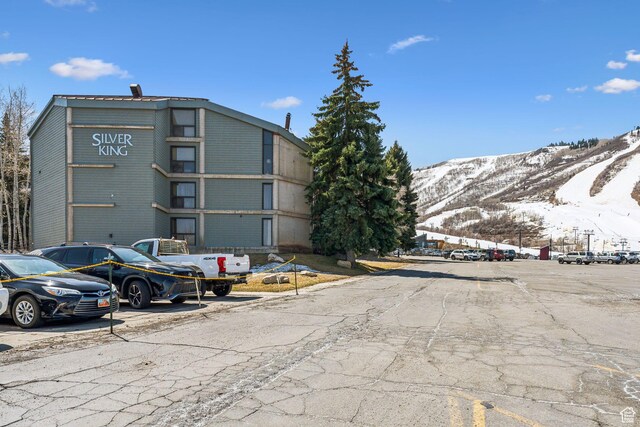 1485 S Empire Ave Unit 216, Park City, UT 84060 - view of building exterior with uncovered parking and a mountain view
