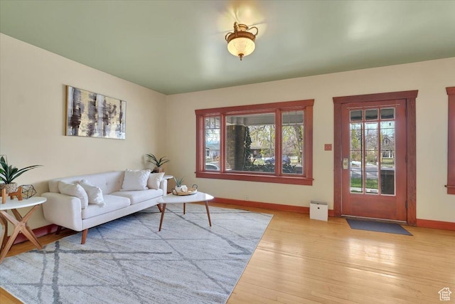 living room featuring hardwood / wood-style flooring and baseboards