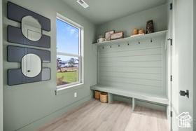 mudroom with baseboards and wood finished floors
