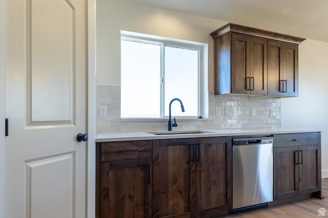 1403 E 1230 S Unit 45, Garland, UT 84312 - kitchen featuring stainless steel dishwasher, tasteful backsplash, a sink, light wood finished floors, and light countertops