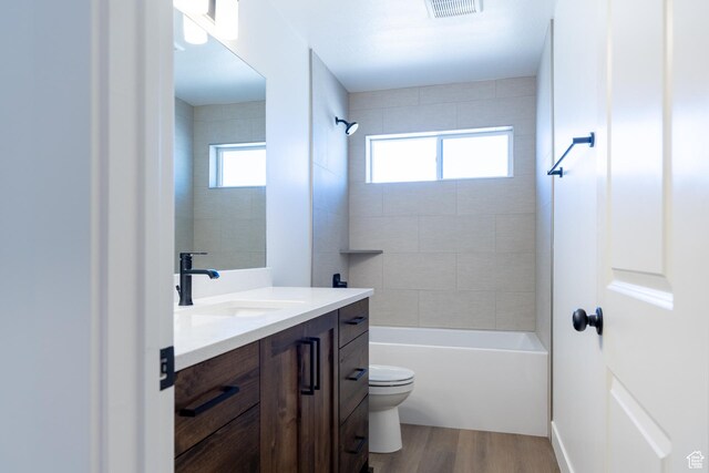 1403 E 1230 S Unit 45, Garland, UT 84312 - bathroom featuring wood finished floors, toilet, plenty of natural light, and  shower combination