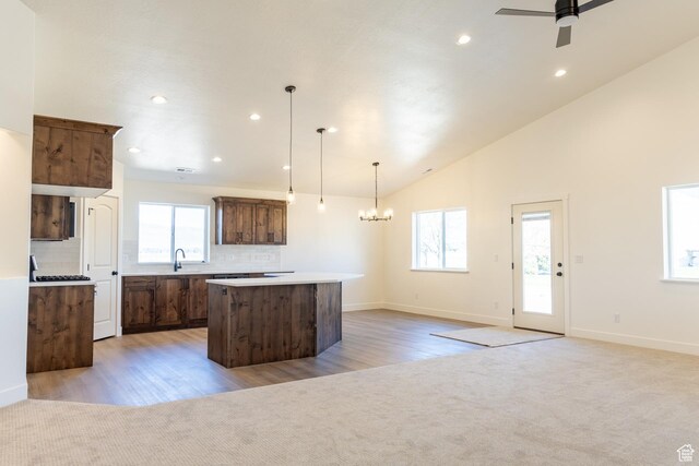 1403 E 1230 S Unit 45, Garland, UT 84312 - kitchen featuring light carpet, a center island, and a wealth of natural light