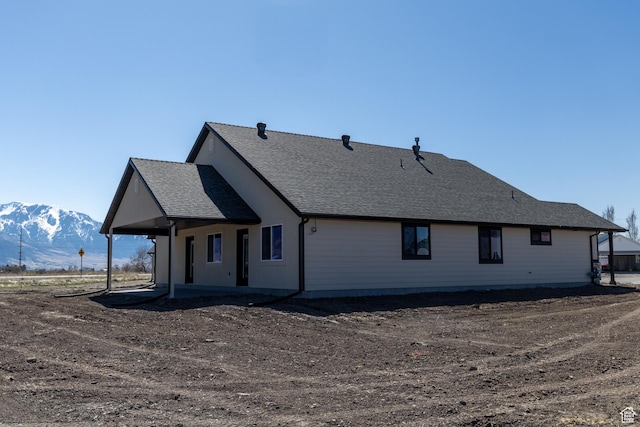 1403 E 1230 S Unit 45, Garland, UT 84312 - rear view of property with a mountain view, a patio, and a shingled roof