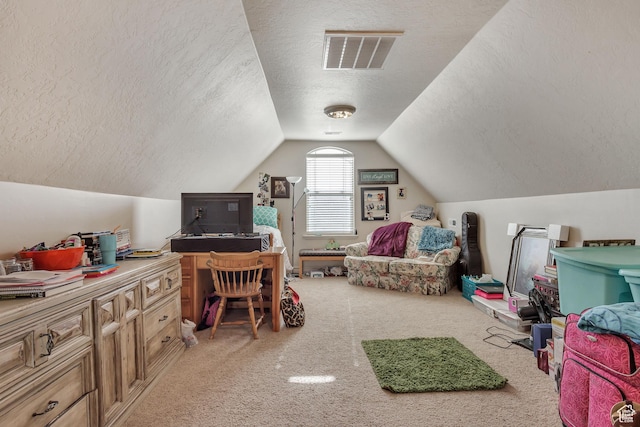 bedroom with carpet floors, lofted ceiling, a textured ceiling, and visible vents