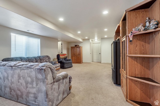 living area with light carpet and recessed lighting
