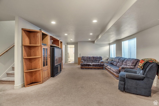 living room featuring light carpet, recessed lighting, and stairs