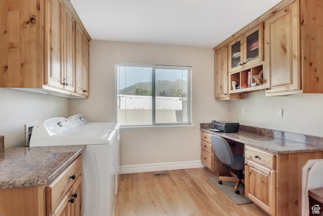 laundry room with washing machine and dryer, baseboards, visible vents, light wood-style floors, and cabinet space