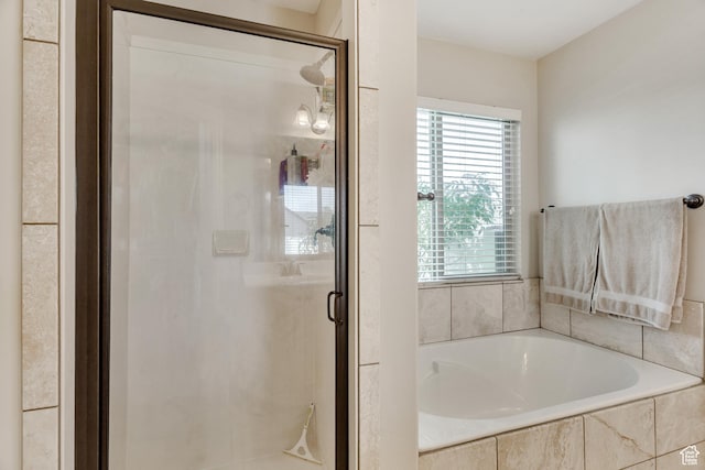 full bathroom with a bath and a stall shower