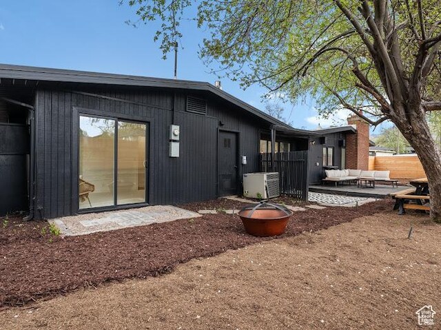 976 E Hyland Lake Dr, Murray, UT 84121 - rear view of property featuring central air condition unit, a patio area, fence, and an outdoor living space