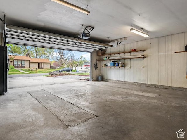 976 E Hyland Lake Dr, Murray, UT 84121 - garage with freestanding refrigerator, wooden walls, and a garage door opener